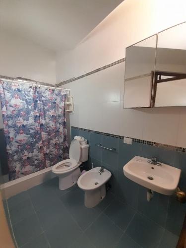 a bathroom with two toilets and a sink at Las Palmeras by Graziano in Boca Chica