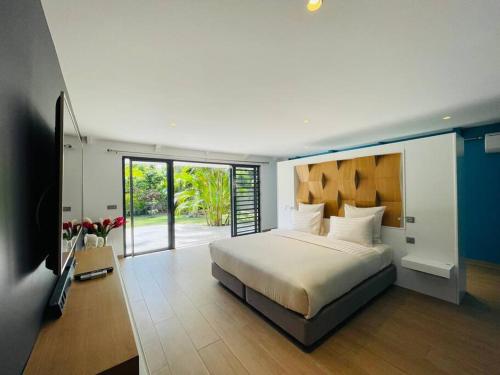 a bedroom with a bed and a television in it at Villa Moana Reva in Bora Bora