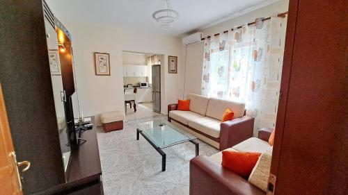 a living room with a couch and a table at Adi's house in Tirana