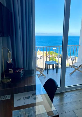 a room with a balcony with a view of the ocean at Il Tramonto in Calvi
