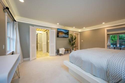 a large bedroom with a bed and a window at Hobbs Mill with Theatre, Ping Pong, and Pet-Friendly in Layton