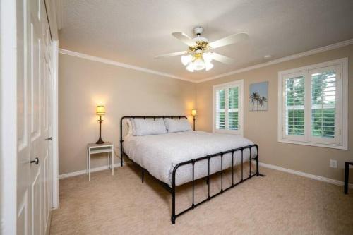 a bedroom with a bed and a ceiling fan at Hobbs Mill with Theatre, Ping Pong, and Pet-Friendly in Layton