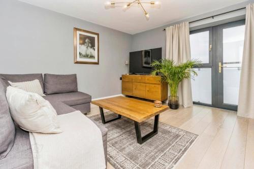 a living room with a couch and a table at Modern Hut in Belfast in Belfast