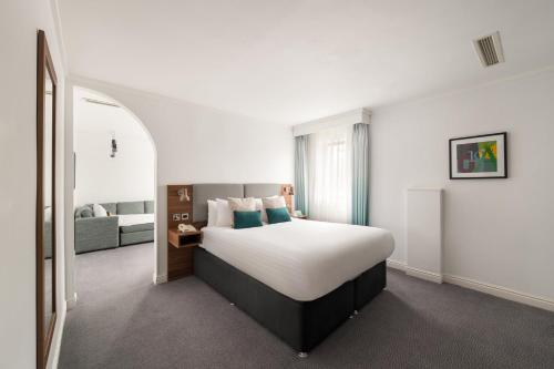 a hotel room with a bed and a couch at Holiday Inn Birmingham Bromsgrove by IHG in Bromsgrove