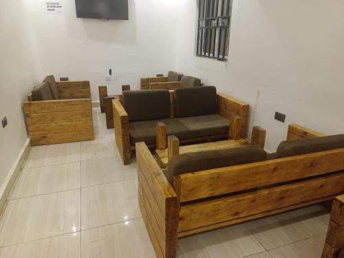 a row of chairs and tables in a room at Skenyo Hotel & Apartments in Ketti