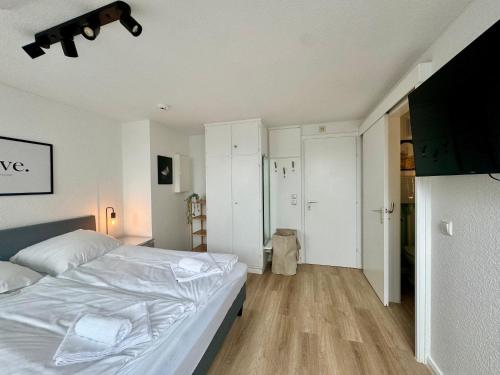a bedroom with a white bed in a room at gina stay - Ferienwohnung 200m vom Strand in Büsum in Büsum