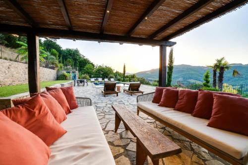 a group of benches on a patio with mountains in the background at Villa Destino Italy, Umbria Tuscany boarder in Montone
