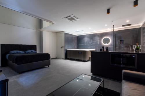 a bedroom with a bed and a kitchen with a sink at SUITE Esbly, Jacuzzi, Terrasse, Disneyland in Esbly