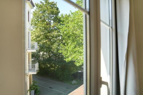 an open window with a view of a street at book2stay modernes Apartment OLMA-Areal in St. Gallen