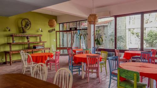 a restaurant with red and blue tables and chairs at Viajero Colonia Hostel in Colonia del Sacramento