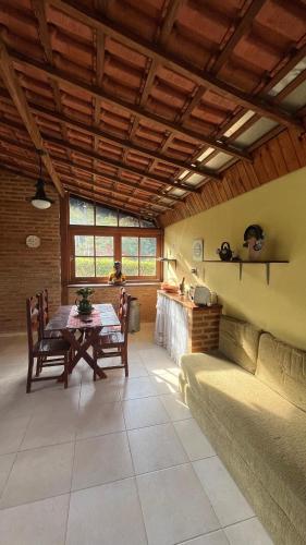 a living room with a table and a couch at Chalé da Montanha in Resende