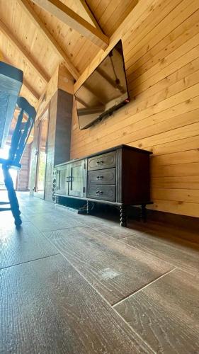 a room with a wooden wall with a mirror on the wall at A Bre Da Bre Family Club in Niš