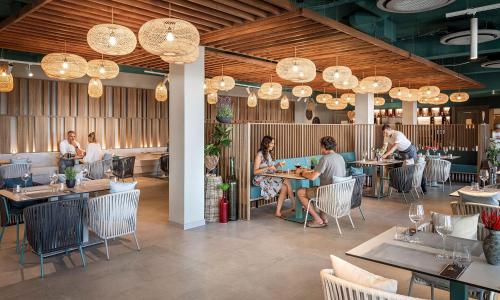 a group of people sitting at tables in a restaurant at Aminess Style Camping Avalona Resort - Pitches in Povljana