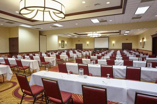 a banquet hall with white tables and chairs at Holiday Inn & Suites Chicago-Carol Stream Wheaton by IHG in Carol Stream