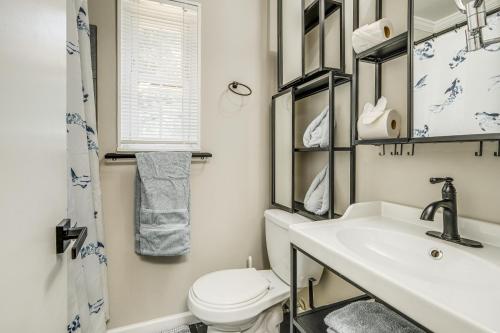 a bathroom with a sink and a toilet at Arlington Townhome with Furnished Patio! in Arlington
