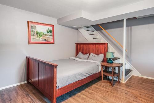 a bedroom with a bed and a staircase at Arlington Townhome with Furnished Patio! in Arlington