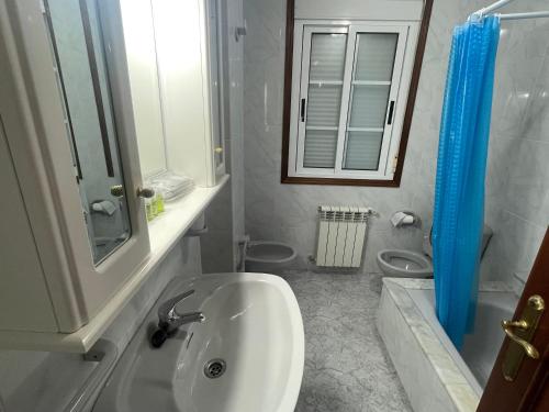 a white bathroom with a sink and a mirror at Casa - Chalet en Barizo - Malpica de Bergantiños in A Coruña