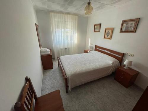 a bedroom with a bed and two tables and a window at Casa - Chalet en Barizo - Malpica de Bergantiños in A Coruña