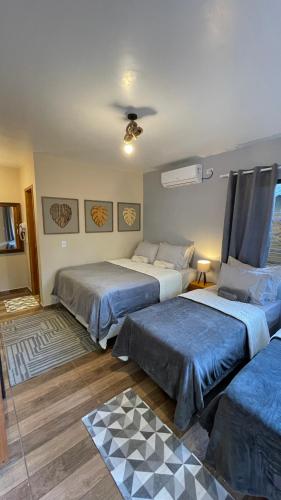 a bedroom with two beds and a ceiling at Pousada Cair do Sol in Ilha do Mel