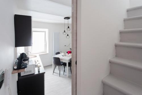 a kitchen and dining room with a table and stairs at La Dolce Vita in Carpinone