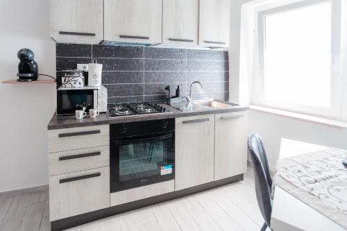 a kitchen with a stove and a sink at La Dolce Vita in Carpinone
