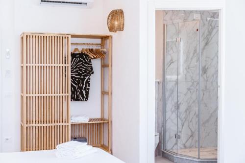 a bathroom with a glass shower and a bed at Suite The Mana Vista Mare in Centro - Casamicciola Terme in Ischia