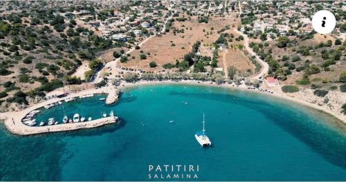 an island with a boat in a body of water at Rooms the other side of the island by Patitiri in Saterlí