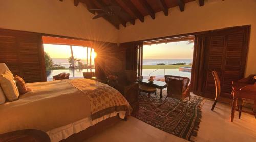 a bedroom with a bed and a view of the ocean at Estate Casas Enjoy 3000 USD Credit For Your Holiday Stay in Punta Mita