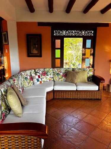 a living room with a white couch and a window at Villa Veneto in Villa de Leyva