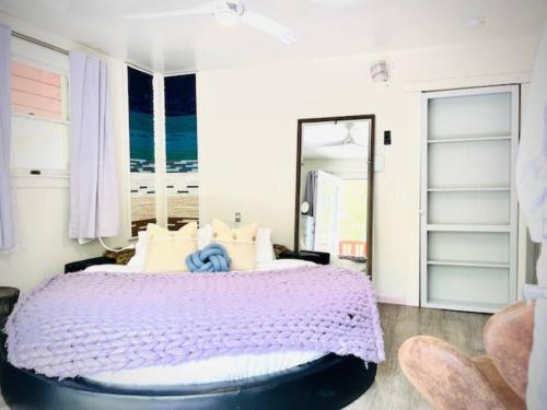 a bedroom with a purple bed with a view of the ocean at Catskill Cabin, Cool Apartment, 2nd Floor in Shandaken