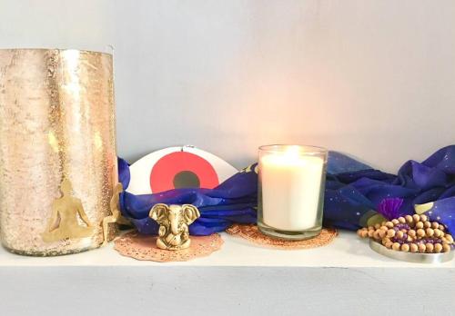 a candle sitting next to a ball and a candle holder at Catskill Cabin, Cool Apartment, 2nd Floor in Shandaken