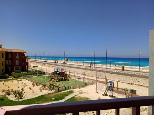 a view of a beach with a playground at Porto Luxury Rentz in Marsa Matruh