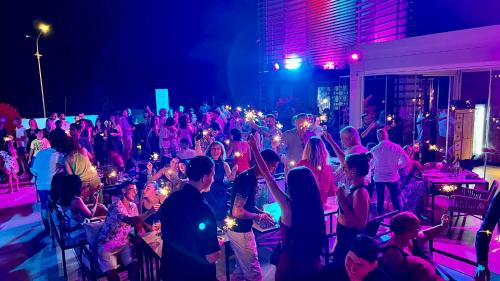 a crowd of people at a party at night at Il Fogliano Hotel New Life in Latina