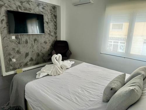a bedroom with a bed with a swan decoration on it at Precioso piso Jávea in Jávea