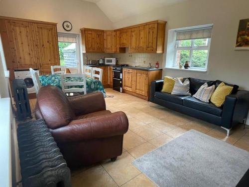 a living room with a couch and a table at Cottage in the Dublin mountain in Dublin