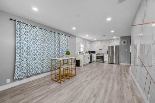 a kitchen with a table in the middle of a room at Modern & Spacious 3BR Retreat on Prime Location in Houston