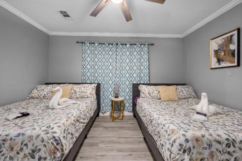 a bedroom with two beds with white swans on them at Modern & Spacious 3BR Retreat on Prime Location in Houston