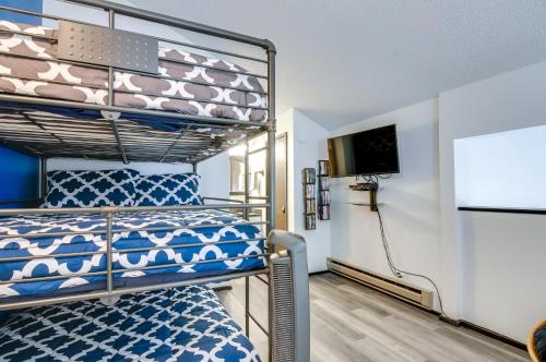 a bedroom with a bunk bed and a flat screen tv at Ski-InandOut Condo with Hot Tub Access in Brian Head! in Brian Head
