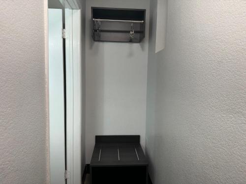 a small room with a black bench in a room at Motel 6 Hollywood in Los Angeles