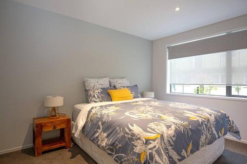 a bedroom with a large bed and a window at Home from home Central City Apartment in Christchurch