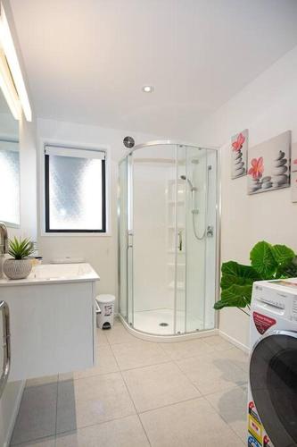 a bathroom with a shower and a sink at Home from home Central City Apartment in Christchurch