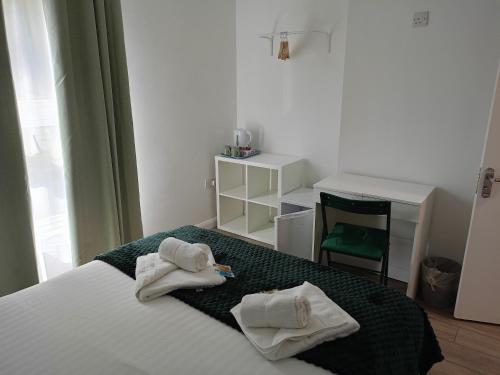a bedroom with a bed with towels on it at Prestige in Cambridge
