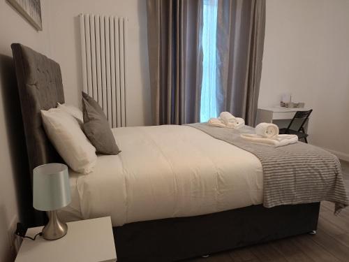 a bedroom with a bed with towels on it at Prestige in Cambridge