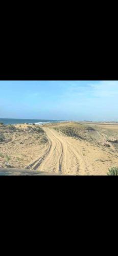 a dirt road in the middle of the desert at Costa Beach in Bouznika