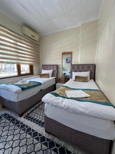 a bedroom with two beds in a room at Apart La Mia in Istanbul