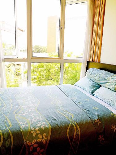 a bed in a room with a large window at Bukit Timah master room in Singapore