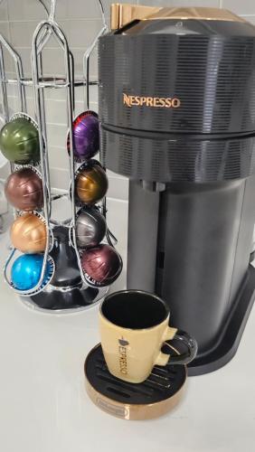 a coffee maker and a coffee cup on a counter at Serenity Inn in Niagara Falls