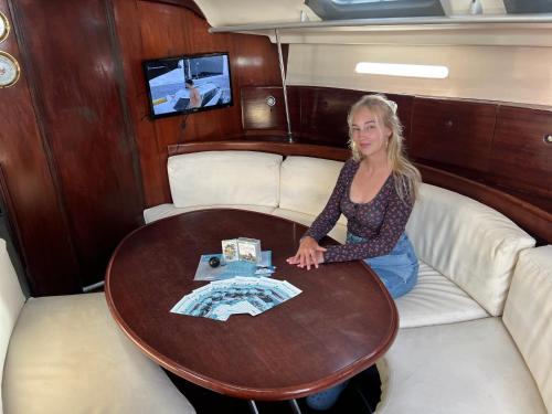a woman sitting at a table in a boat at Carranade yacht in Torquay