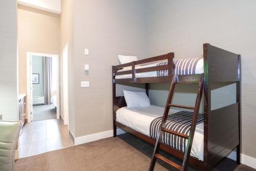 a room with two bunk beds and a ladder at Sandman Hotel Abbotsford Airport in Abbotsford