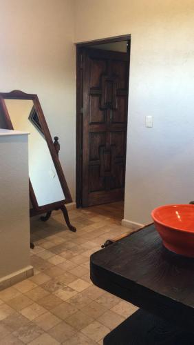 a room with a wooden door and a red bowl at Hacienda Maria Eugenio in Guanajuato